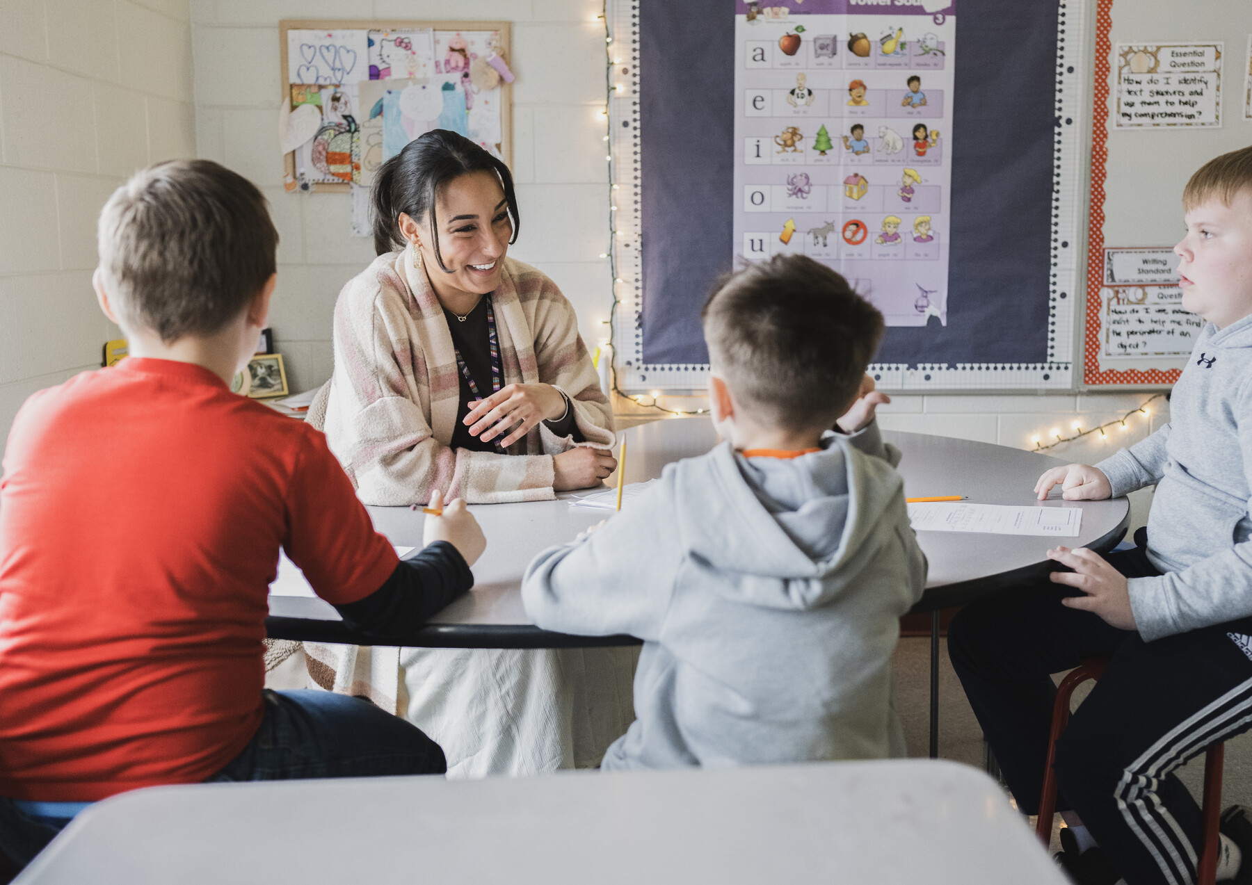 Educator engaging with students during a small-group learning activity