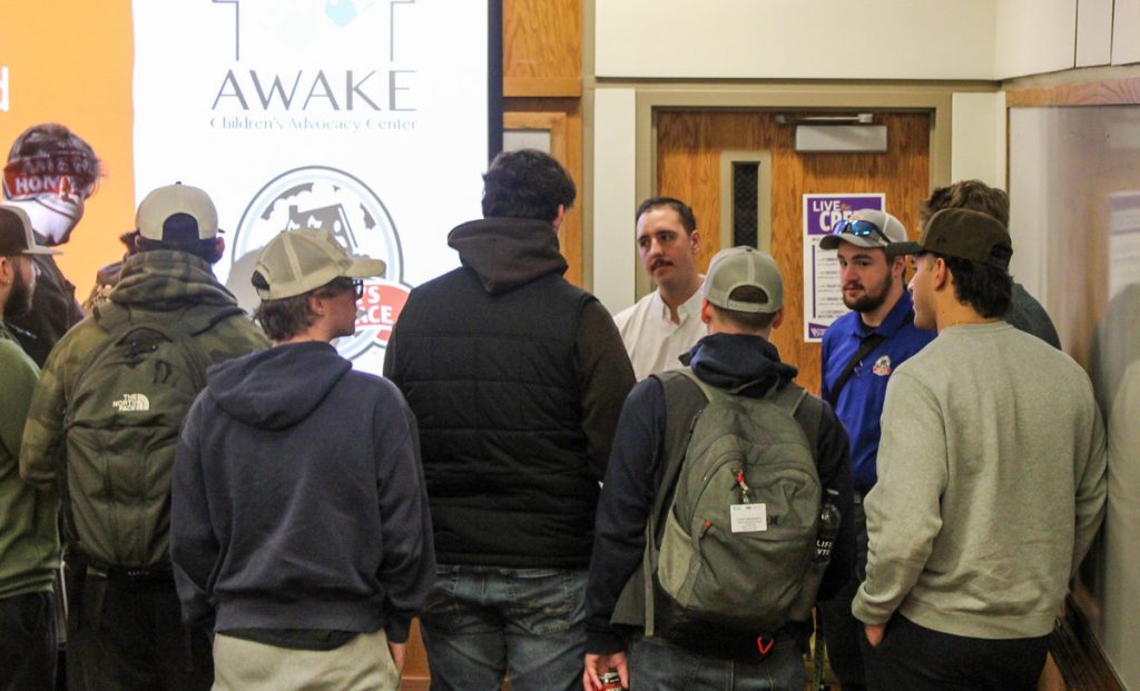 WCU construction management students meet with America's Home Place representatives who provided guidance and donated construction materials for a service project for AWAKE Children's Advocacy Center.