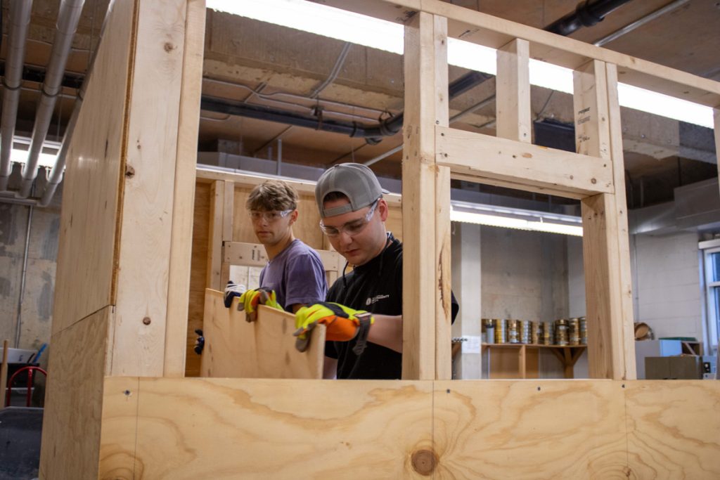 WCU construction management students work on a playhouse for AWAKE Children's Advocacy Center. Materials were donated by America's Home Place.