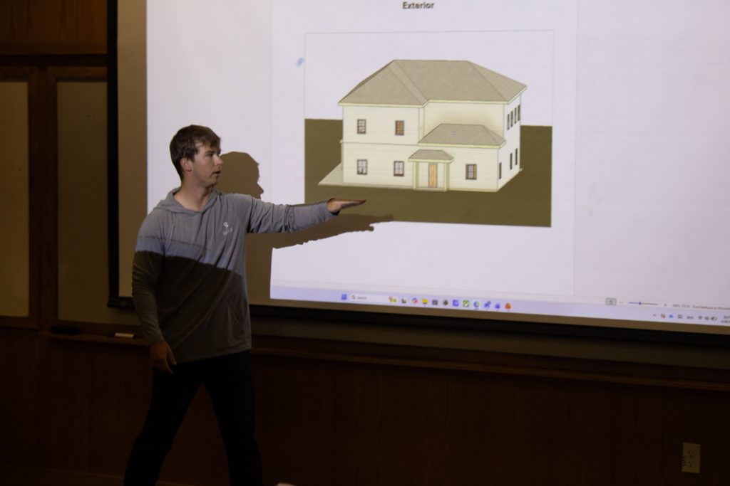 A WCU construction management student presents a rendering of a building design created for AWAKE Children's Advocacy Center.