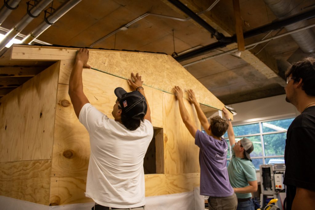 A team of WCU construction management students build a playhouse they designed with support from America's Home Place for AWAKE Children's Advocacy Center.