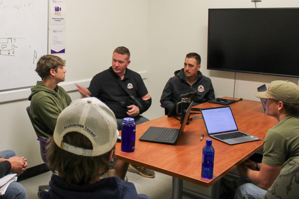 Representatives from America's Home Place meet with WCU construction management students to provide guidance on a playhouse design and building project for AWAKE. America's Home Place donated the construction materials for the project.