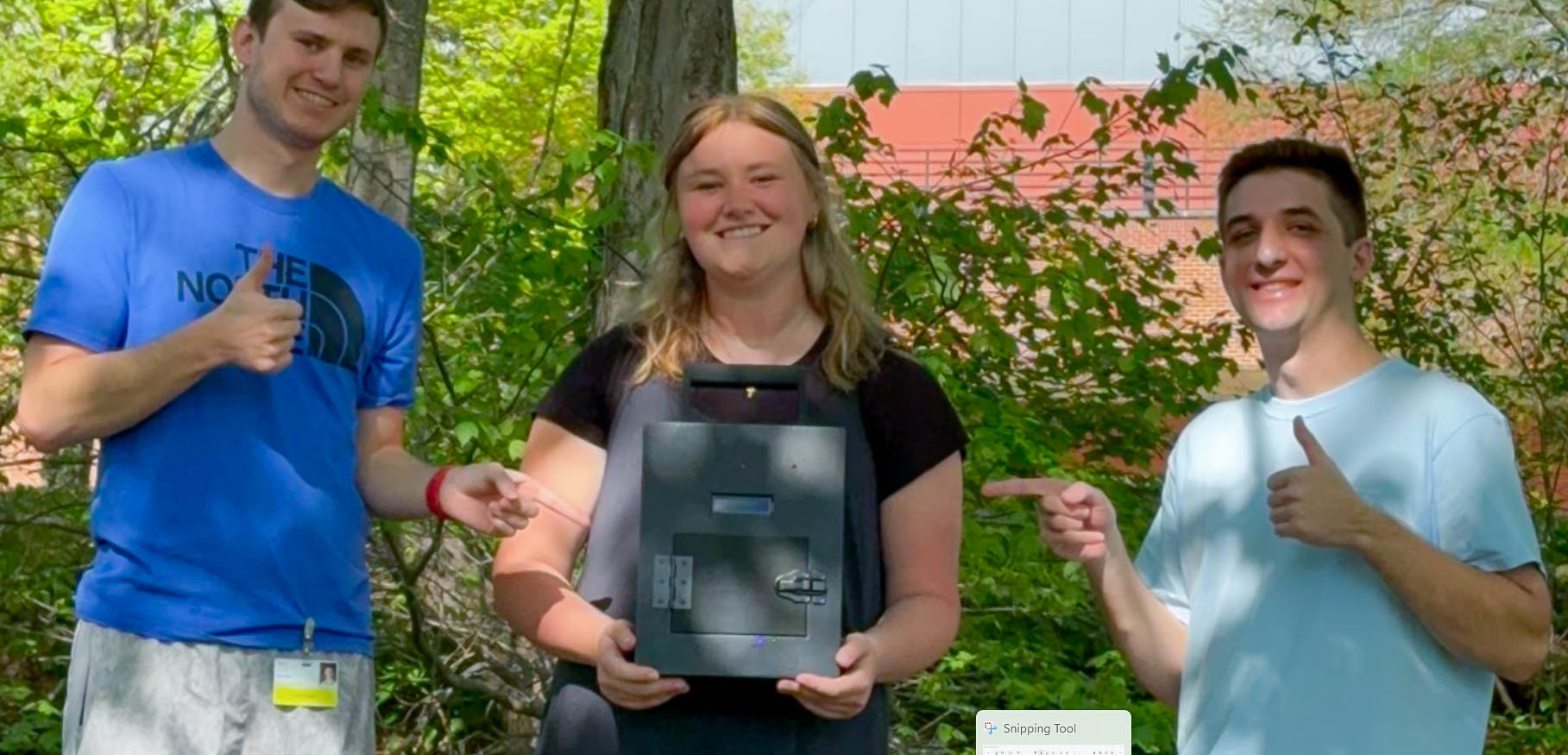 Turbidity Monitoring Project Team holds device