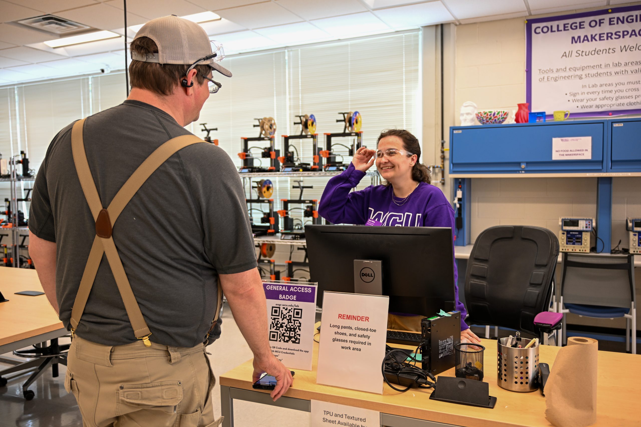 River helping a student check into the Makerspace