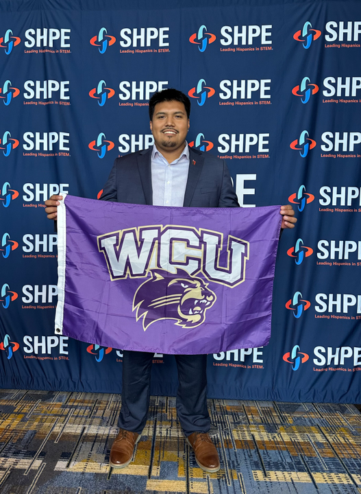 Kevin Elias Juarez holding a WCU flag