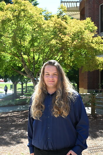 John B. standing outside smiling
