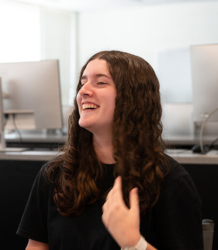 Eleanor B. laughing in a classroom