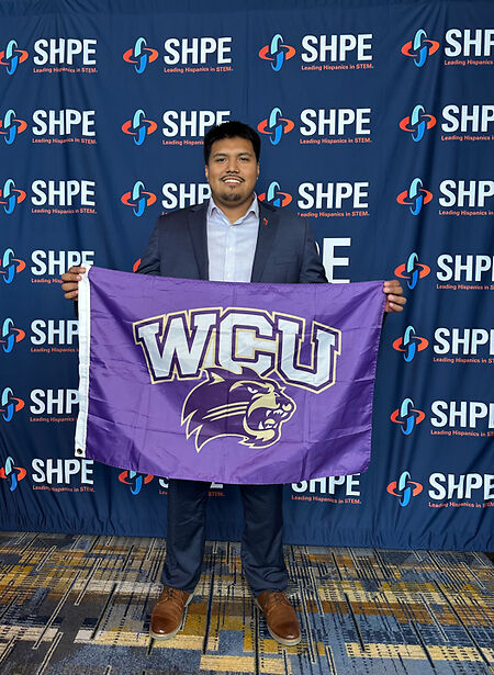Kevin Elias Juarez holding a WCU flag