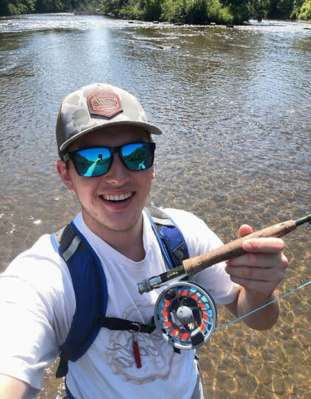 Gavin Lakey holding a fishing rod