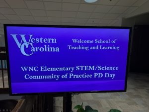 Sign that reads "Western Carolina: Welcome School of Teaching and Learning; WNC Elementary STEM/Science Community of Practice PD Day"
