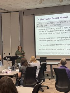 Educators listening to Dr Bricker, the board behind her reads "A Start with Group Norms"